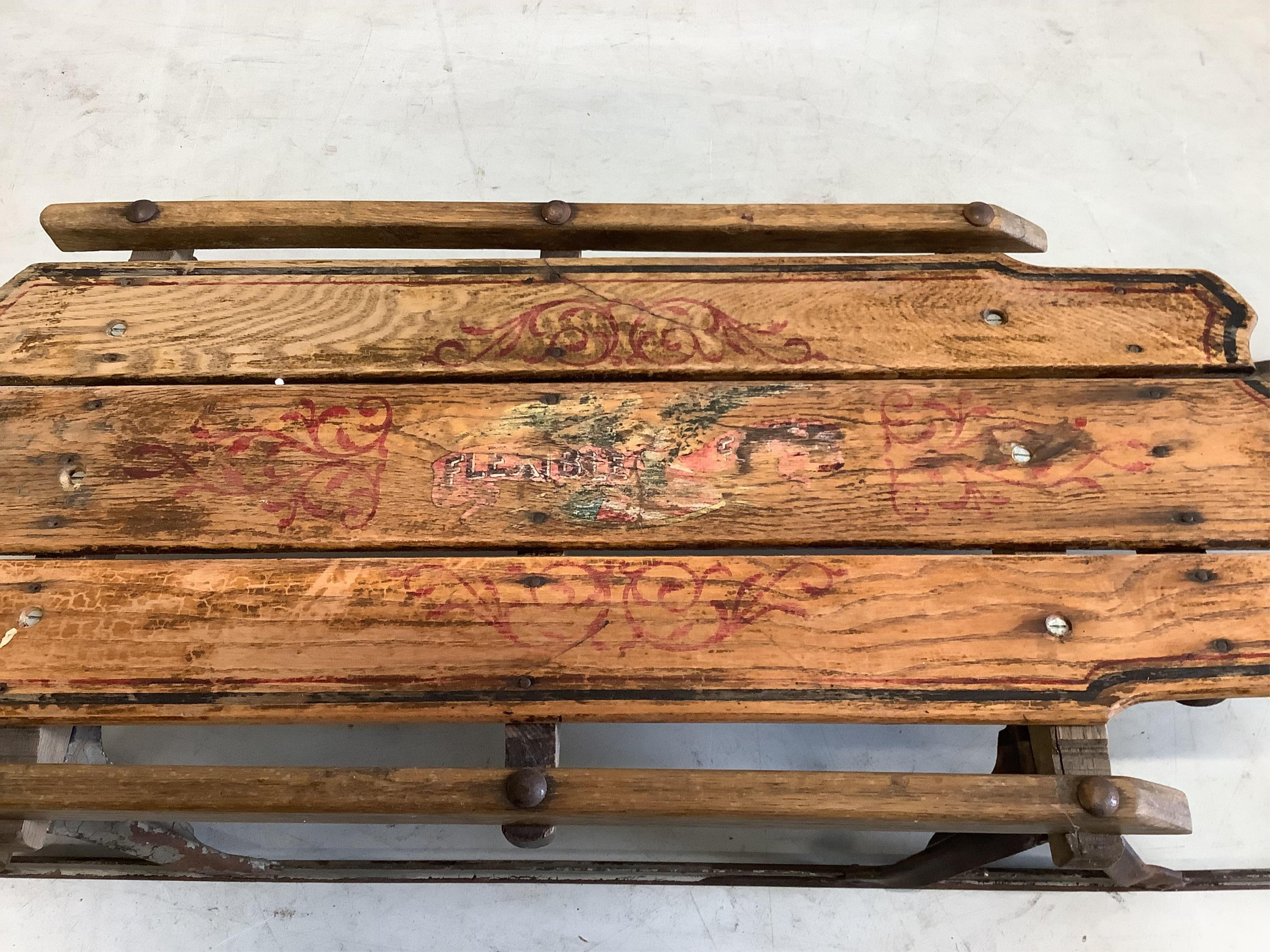 A painted sledge, width 53cm, depth 107cm, height 17cm